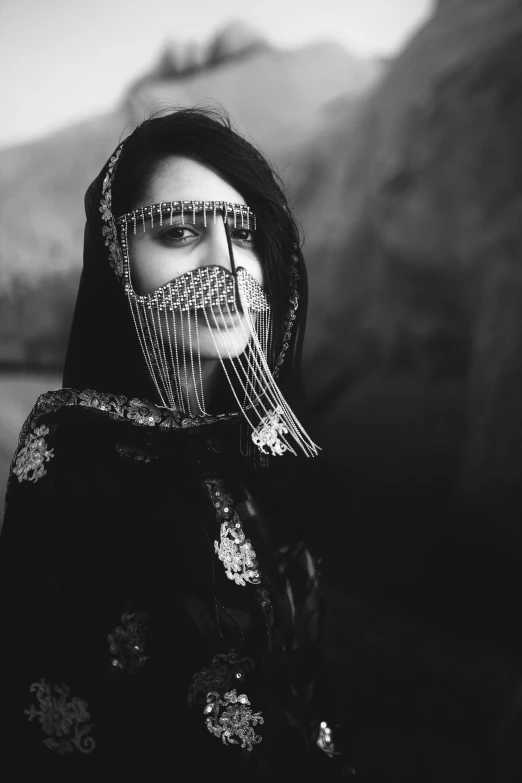 a woman with many long hair holds a brush up to her face