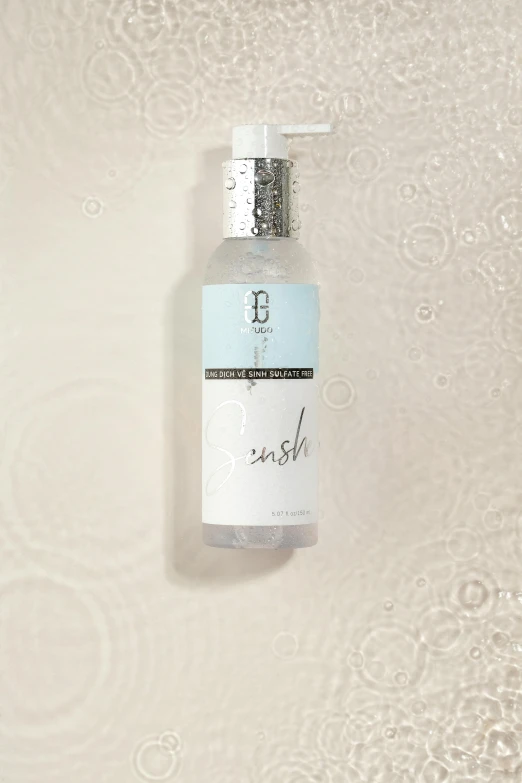 a foaming bottle on a white background, with some white bubbles on it