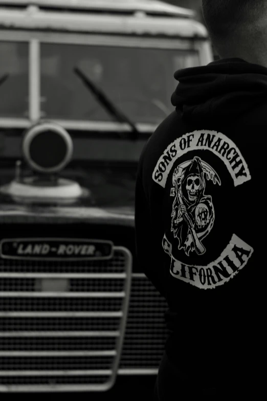 a person standing near an old bus with a skull on it