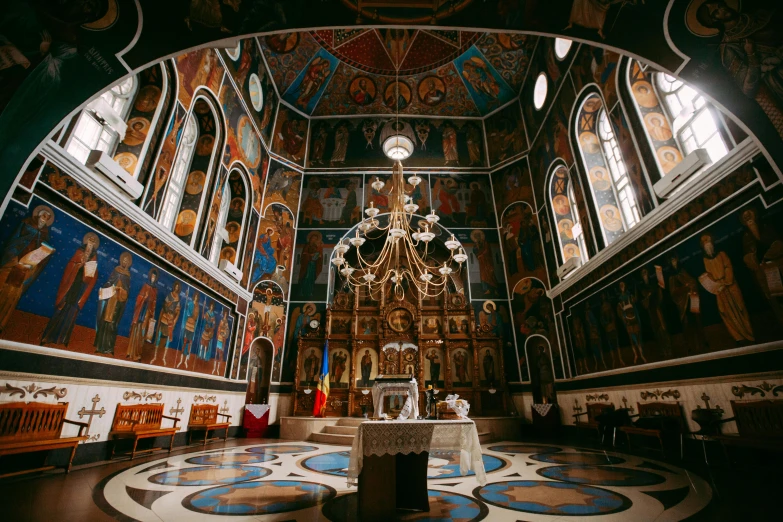 a church with stained glass windows and paintings