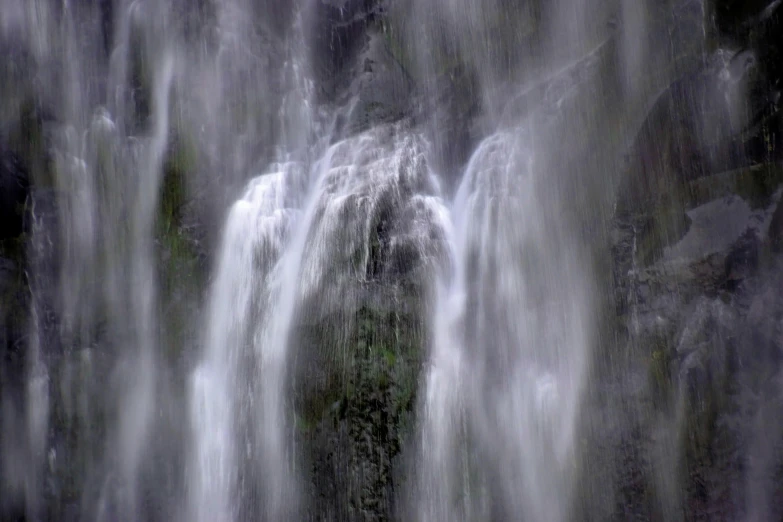 water falling from waterfall during daytime near green plants