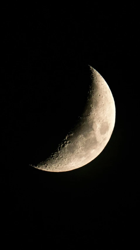 an eclipse in the dark sky with half moon