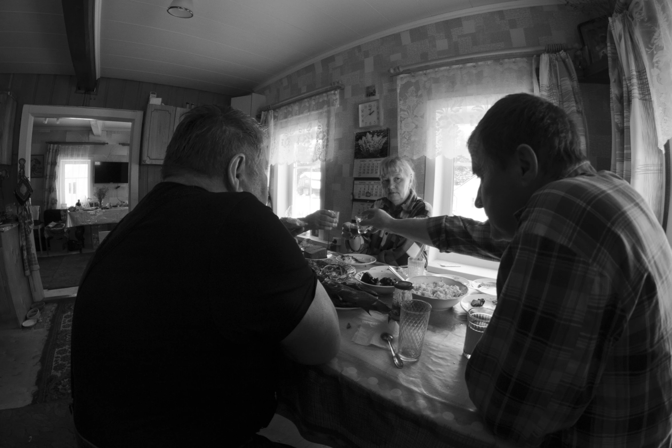 two men are at the counter in front of the window