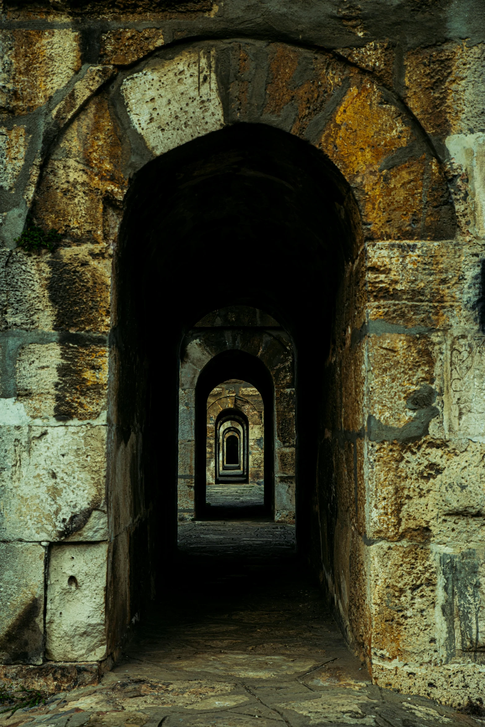 a light at the end of a tunnel in the stone wall