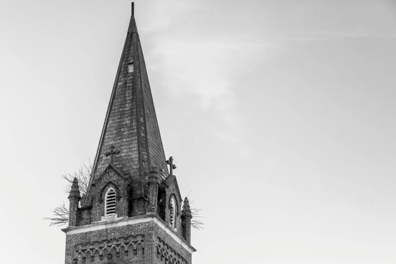 a black and white picture of an old church tower