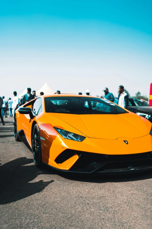 a orange sports car parked on the road