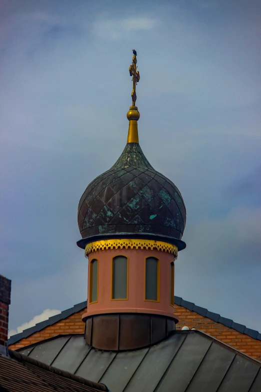 a tall building with a weather vein on top