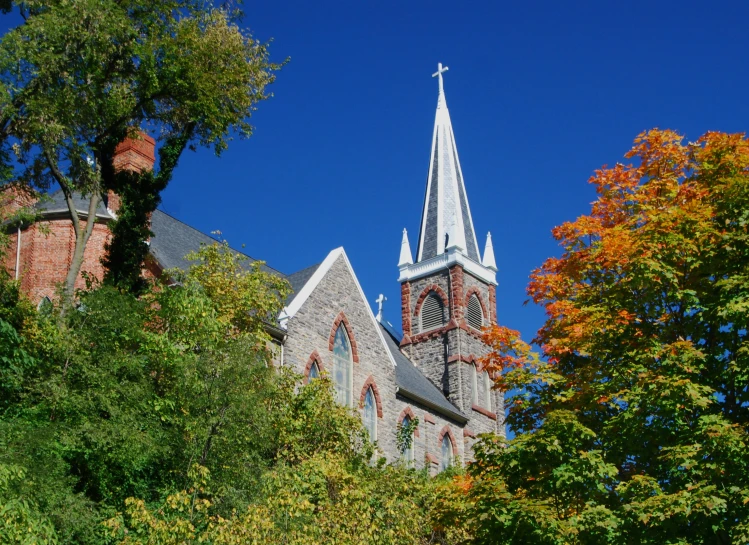 a very tall steeple of a church with a cross on it