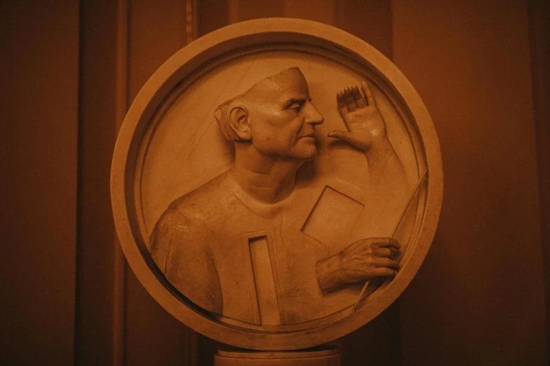 a man is painting a medallion with brush strokes