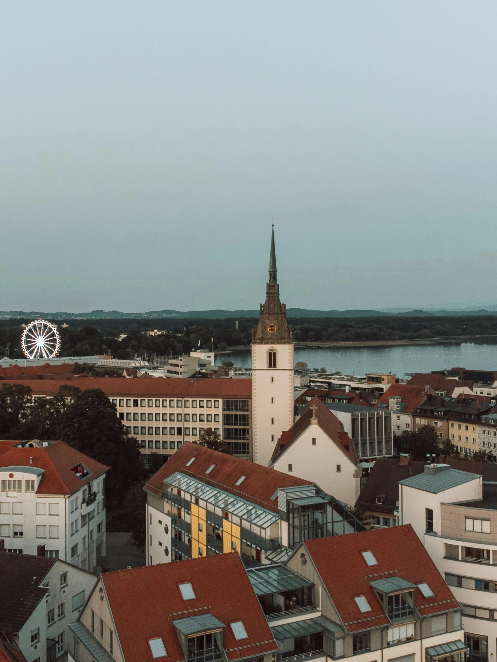 a city with lots of houses and a clock tower