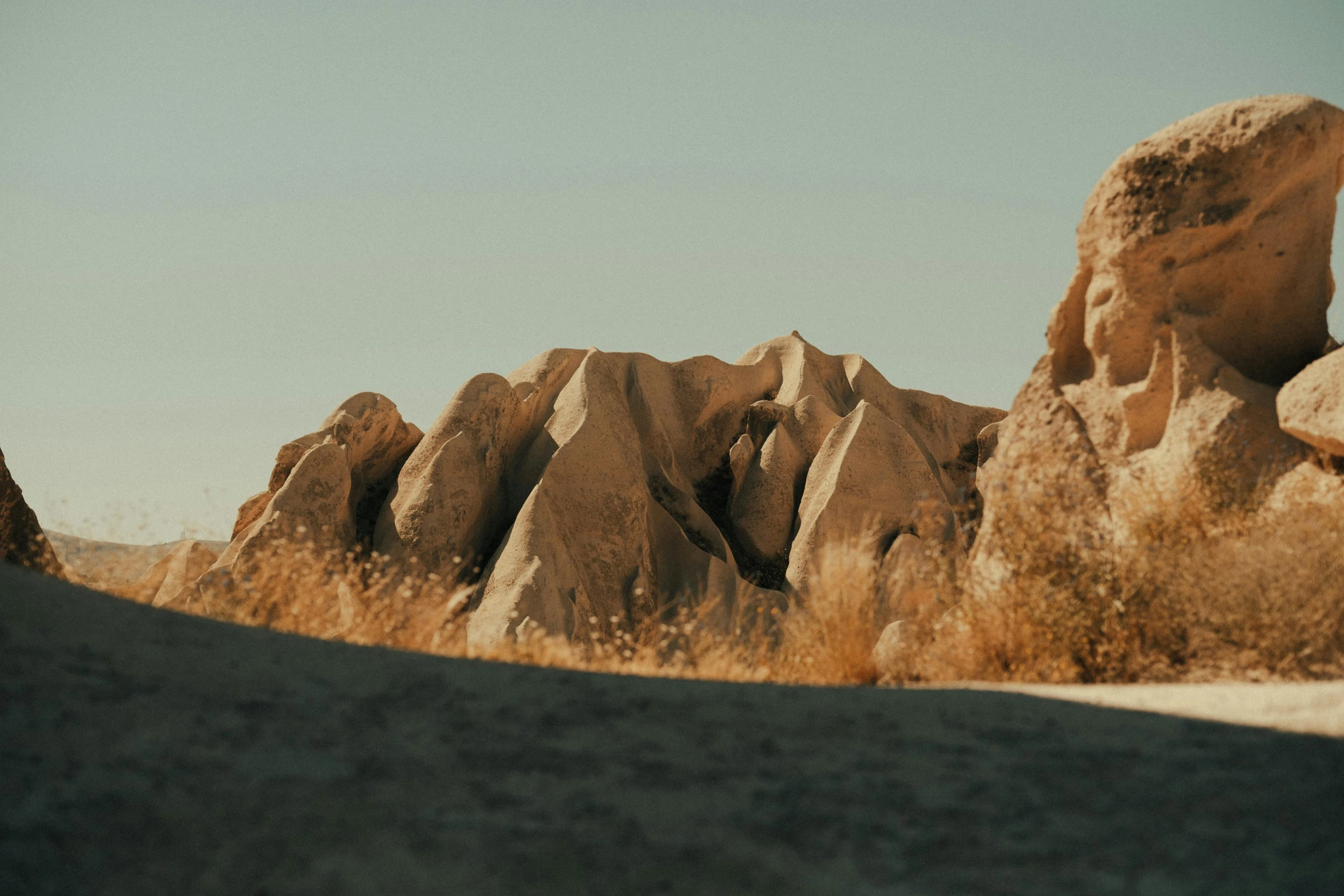 there are many rocks in the desert and one is alone