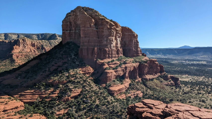 the cliffs of red rocks, mountains and trees in canyons