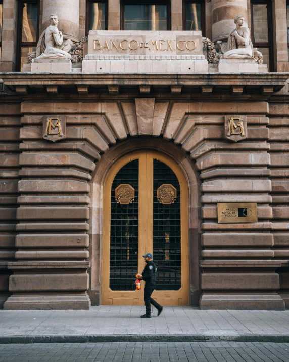 a man walking through a doorway onto the sidewalk