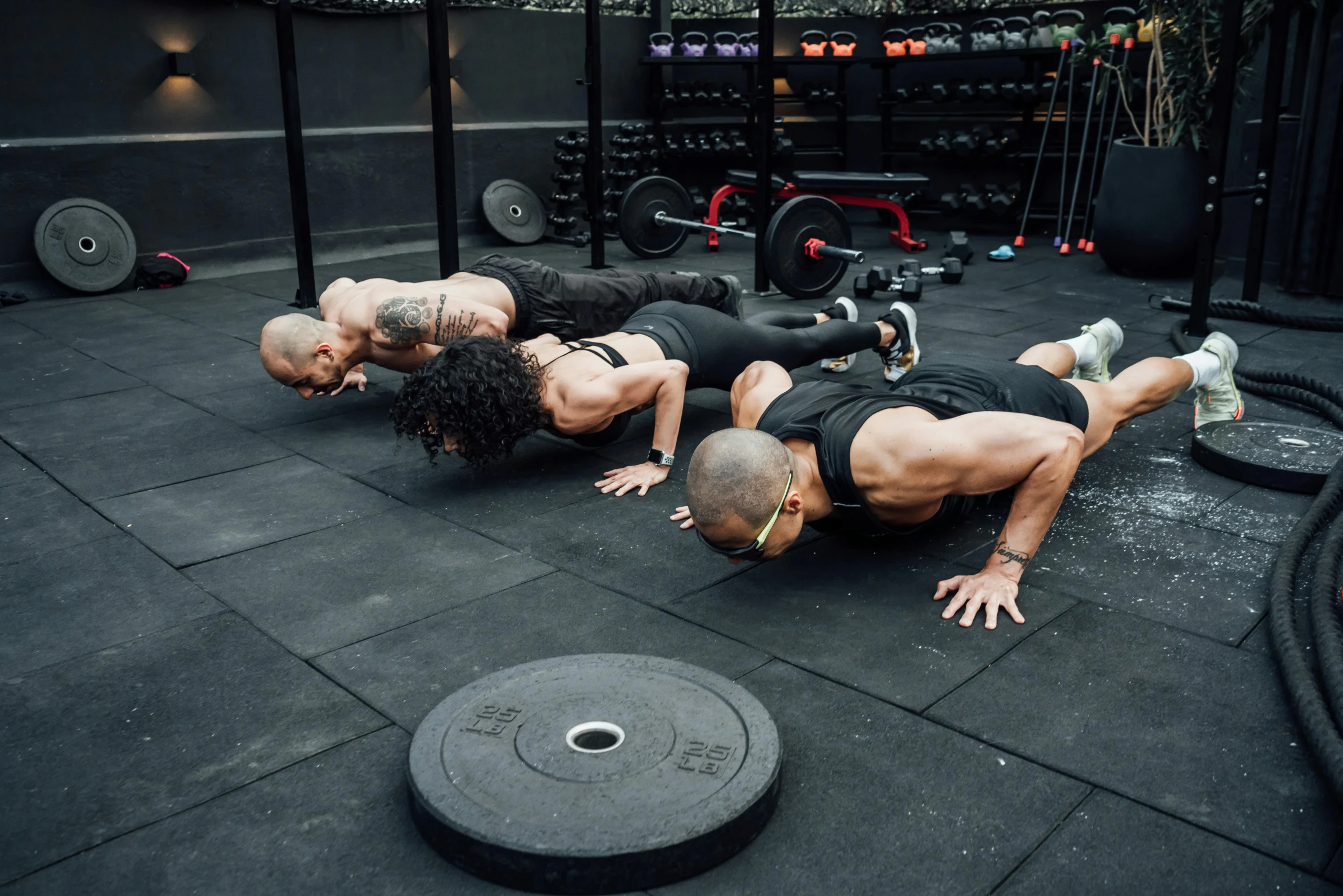 men performing back raises on a gym floor