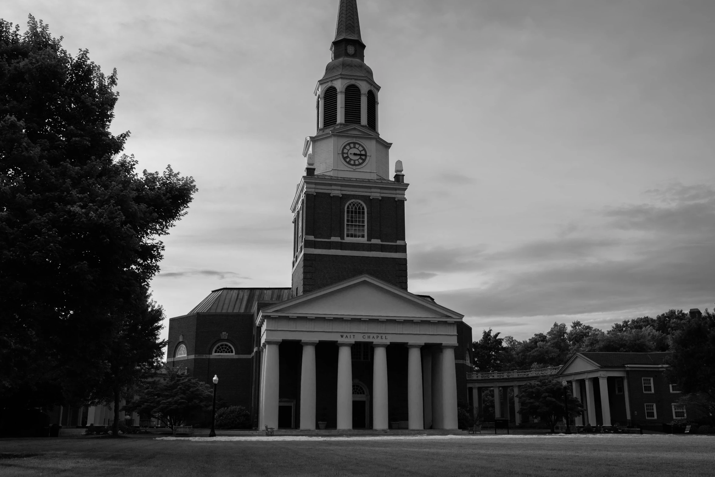 black and white picture of a very tall building with a clock tower