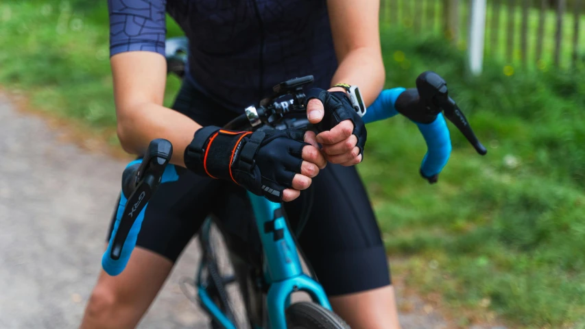 the person is riding a bicycle with their hands in the other