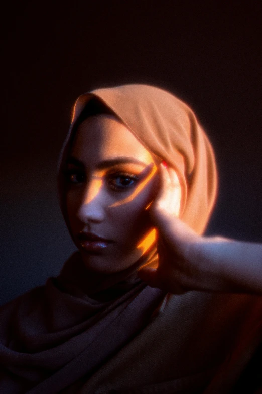 a girl wearing a headscarf putting on makeup