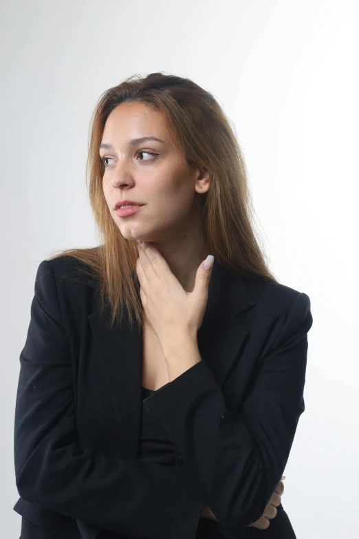 the woman in the black jacket is leaning on her neck