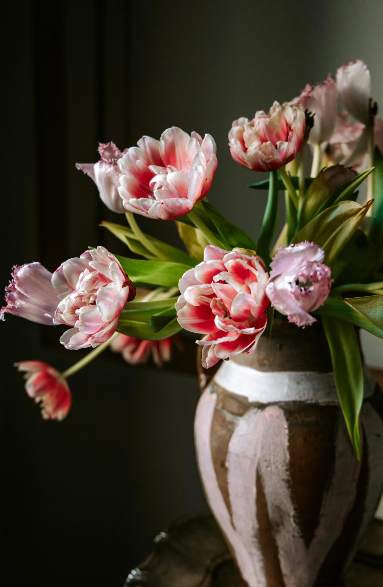 a vase with many flowers inside of it