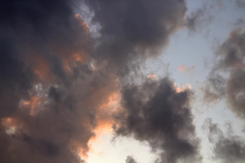 a plane flies through a cloudy sky