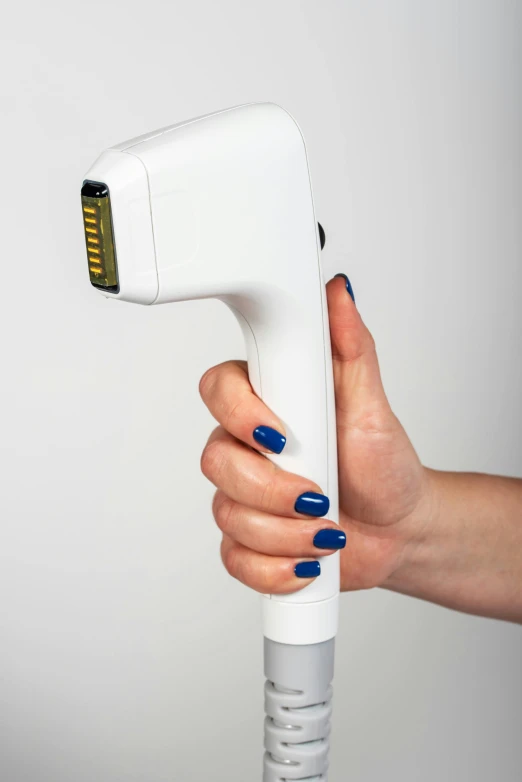 a woman with blue nail polish holds a hairdryer