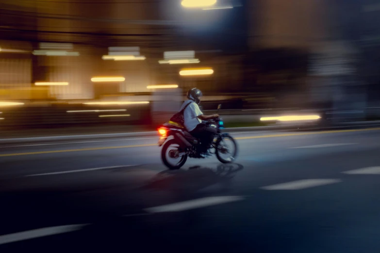 two people riding a motorcycle down the street