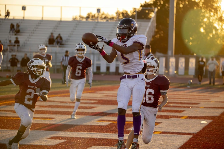 a group of children running down a football field