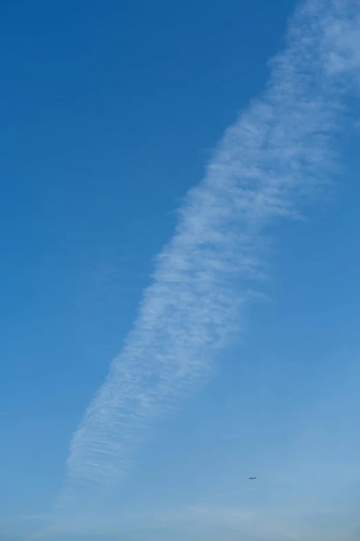 a plane flying in a partly cloudy sky