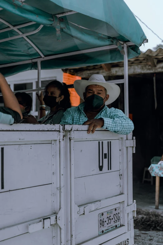 a group of people riding on the back of a truck