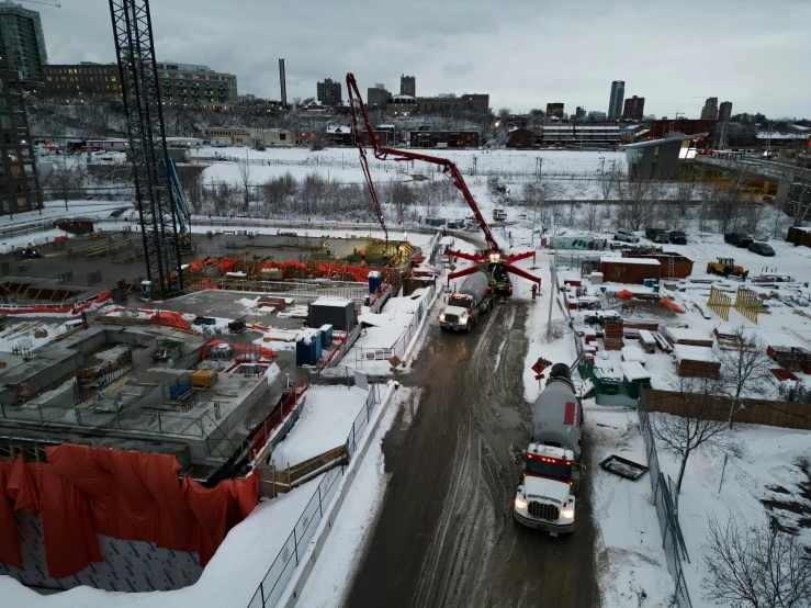 a very large building being constructed in the middle of a snow covered field