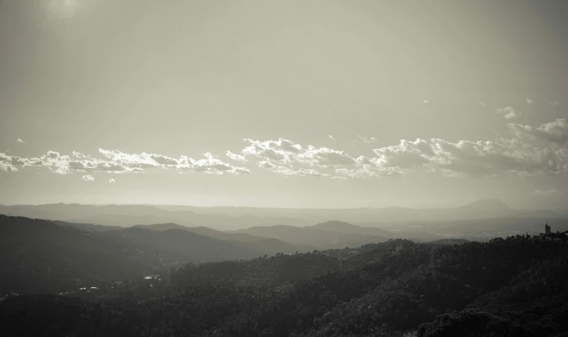 view of an area with trees and hills in the foreground