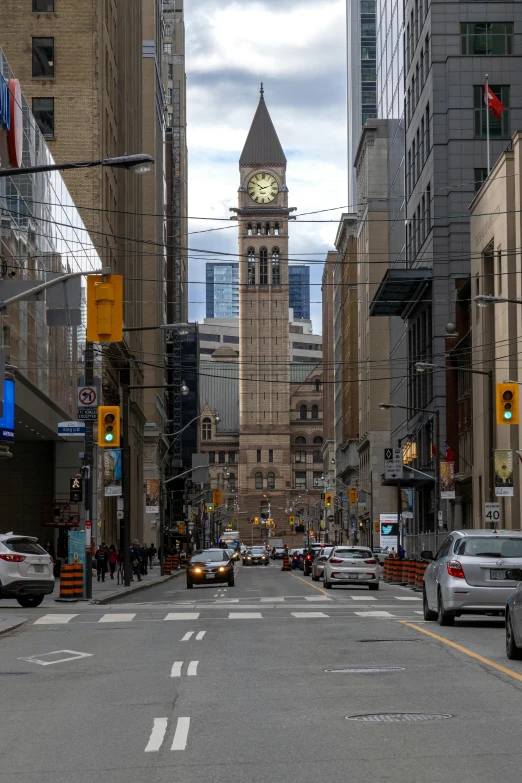 a city street with a clock tower in the background