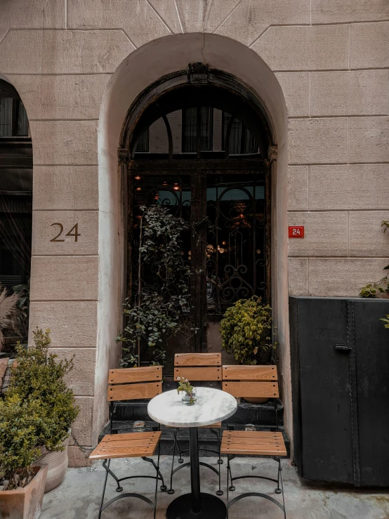 two wooden benches sit in front of a tall building