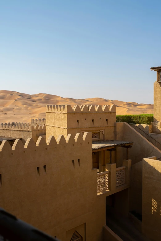 a desert town with small stone buildings with roof tops