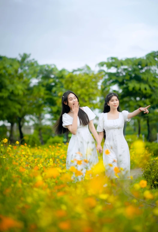 two asian ladies in a field with flowers