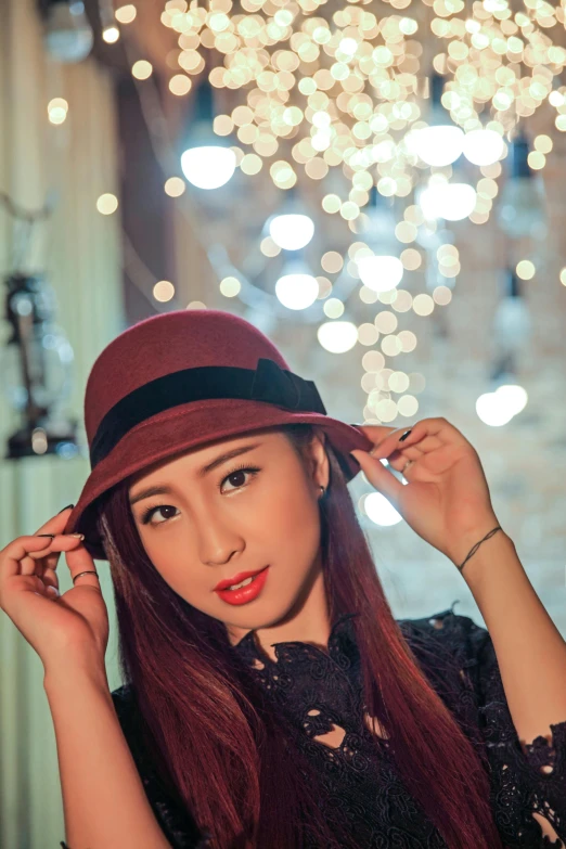 a woman wearing a hat with a black shirt and tie