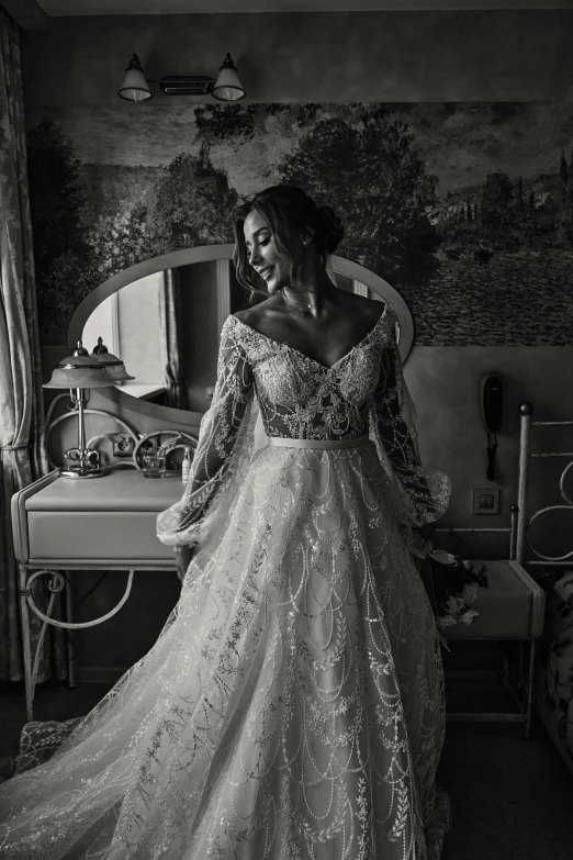 a woman wearing a long wedding dress standing in a room