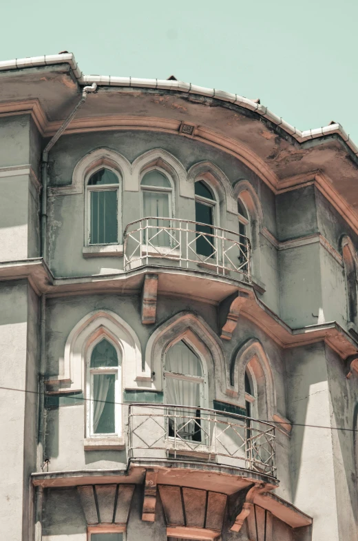 an old building with balconies on a cloudy day