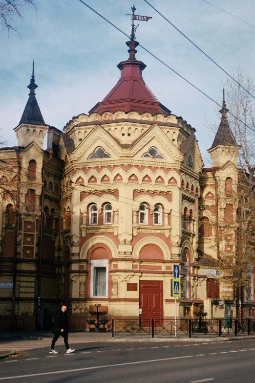 the corner building is on the street near the tree lined sidewalk