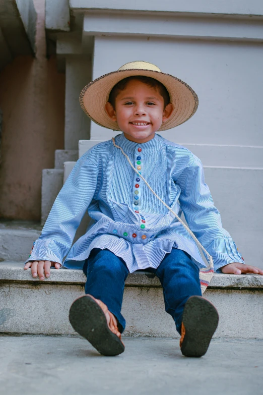  in a straw hat sitting on steps