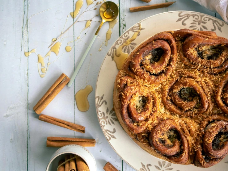 a plate with cinnamon cinnamon rolls on a table