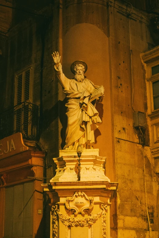 a statue of the roman god person in a hall with a window