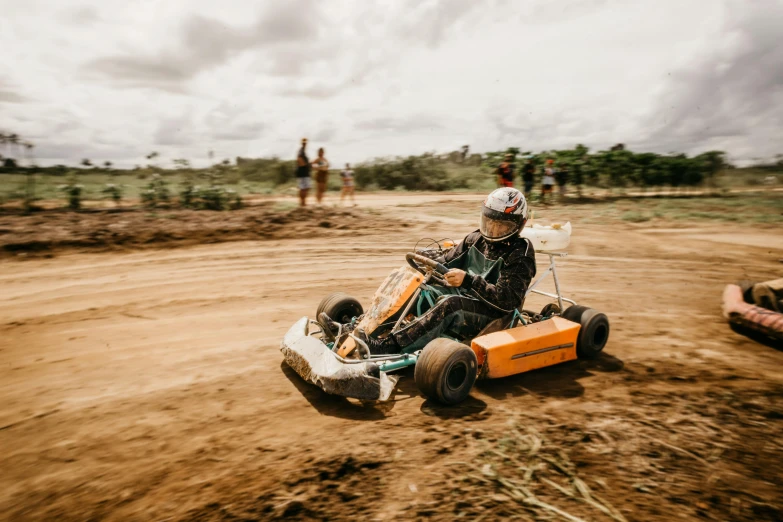 a person riding a vehicle on dirt road