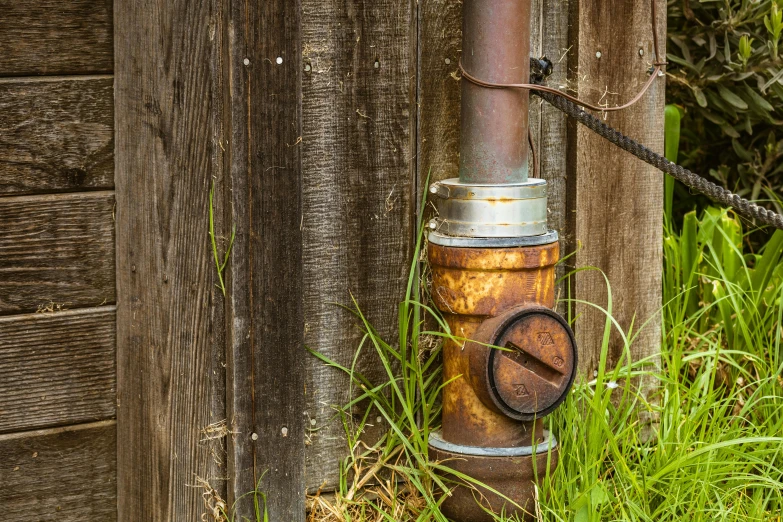 a metal pole connected to a wooden structure