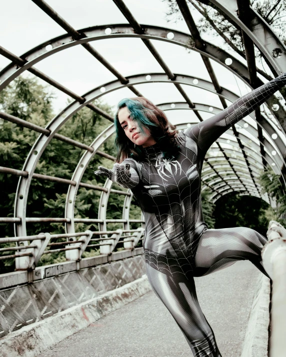 the woman has green hair and black paint on her body