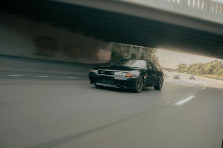 a car that is driving under a bridge