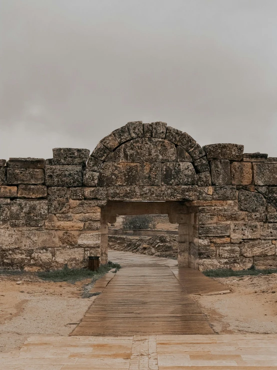 an ancient stone arch and stairs, in front of the great pyramid