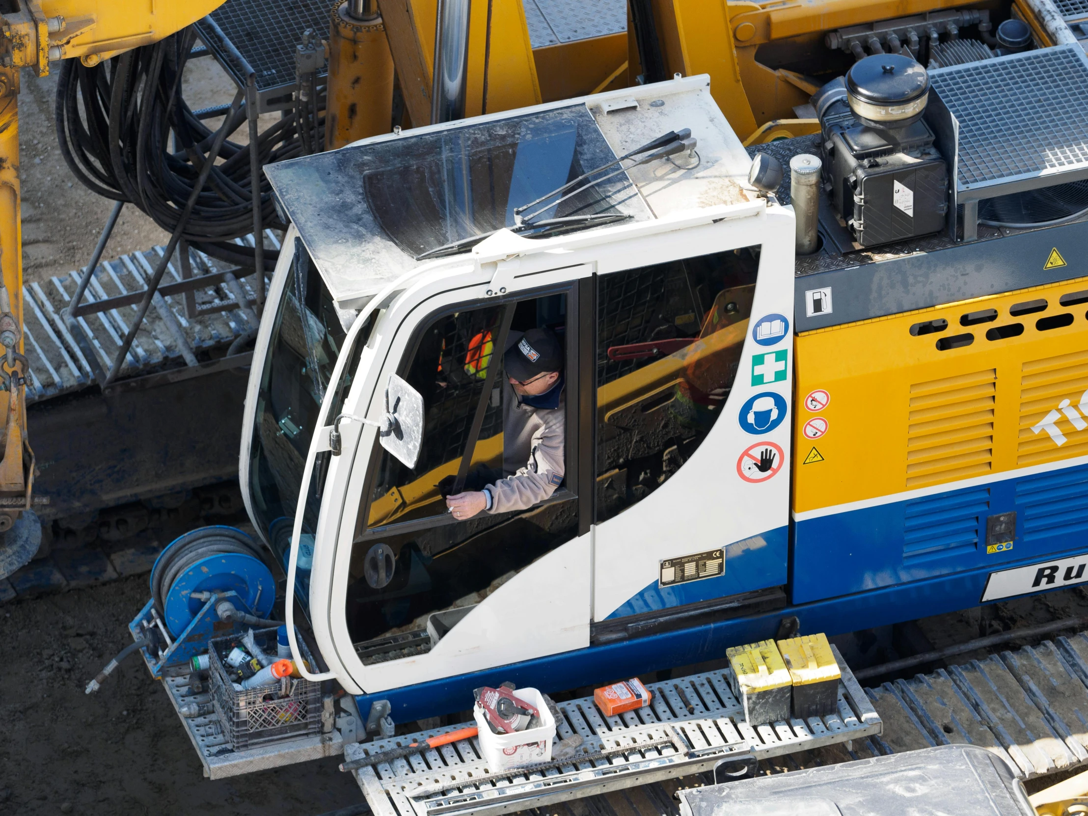 the driver is looking out the window of a construction truck