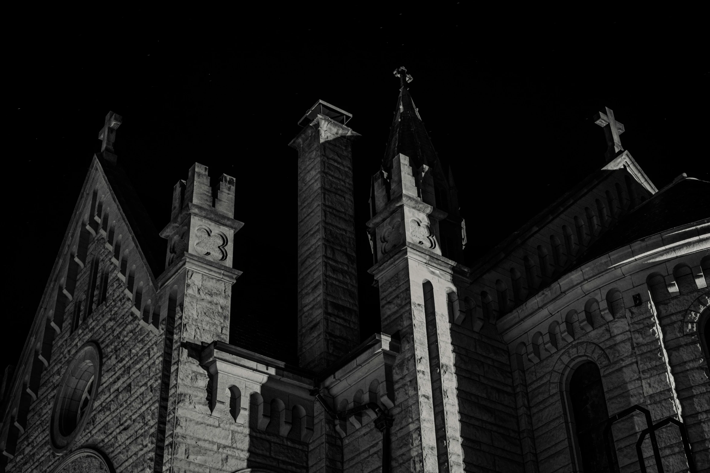 two tall tower like structures in a city at night