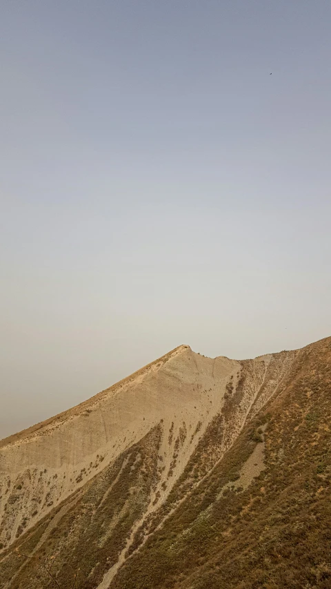 there is a bench sitting on the hill in the desert